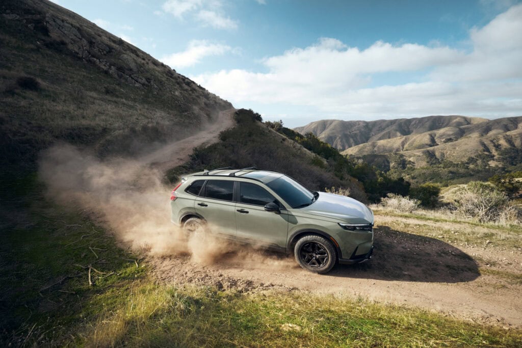 2026 Honda CR-V TrailSport Hybrid driving on a mountain dirt road