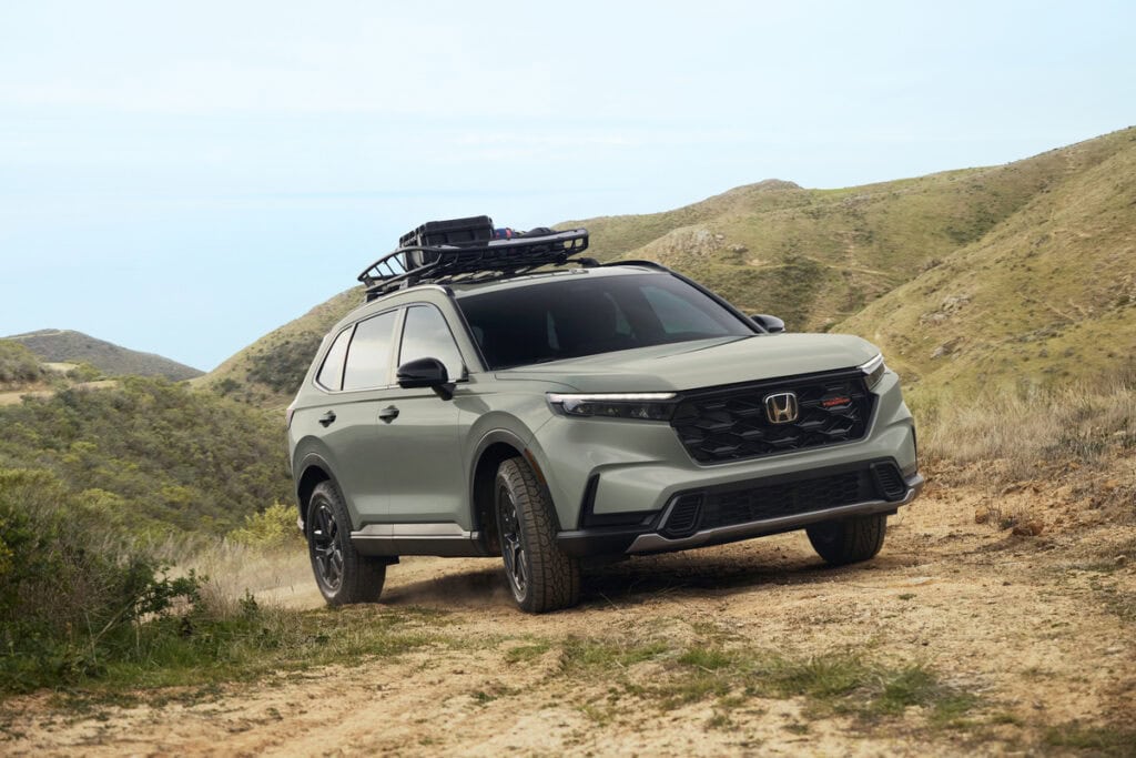 2026 Honda CR-V TrailSport Hybrid equipped with a roof basket on a dirt road