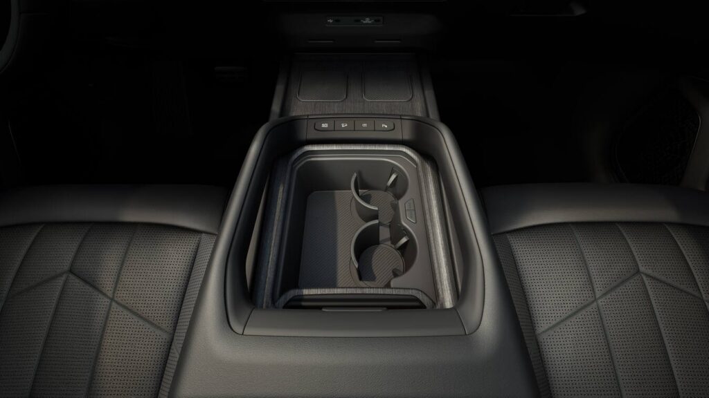 Interior of the 2027 Kia Telluride showing cupholders and storage space in between the front two seat seats