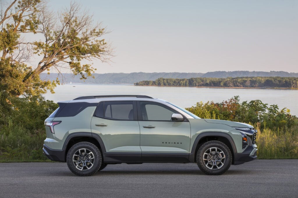 Side profile view of a 2025 Chevrolet Equinox ACTIV parked near a large body of water.