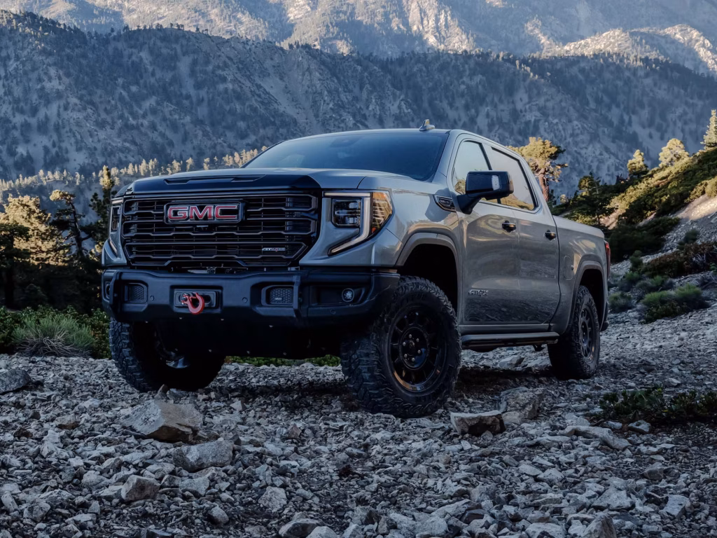2025 GMC Sierra 1500 AT4 parked in the mountains on rocky terrain.