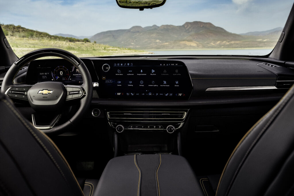 Interior view from second row of 2026 Chevrolet Traverse High Country with Jet Black with Natural Tan interior. Preproduction model shown, actual production model may vary.