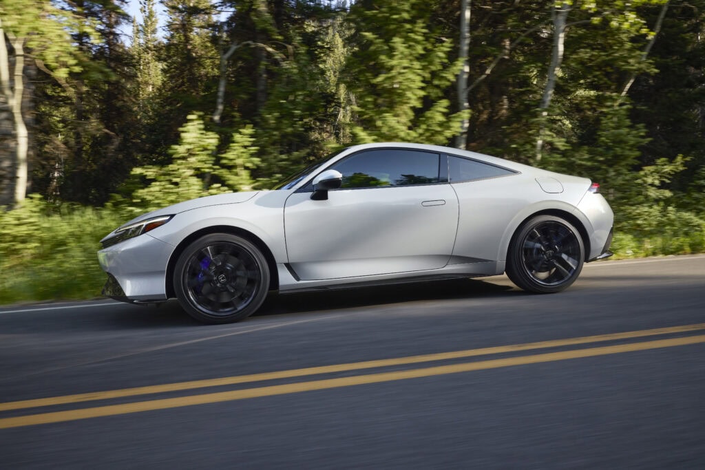 2026 Honda Prelude driving on a mountain road amongst trees