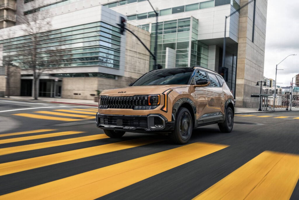 2027 KIA Seltos. Three-quarter view crossing a crosswalk