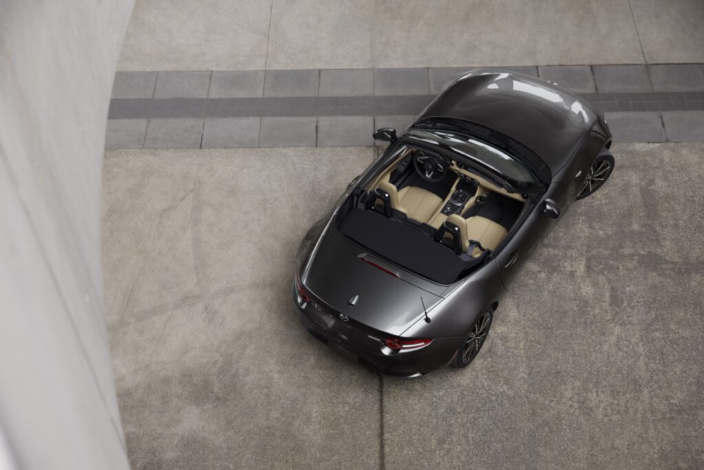 Mazda Miata MX five with the top down picture taken from the roof up vehicle is in Silver 