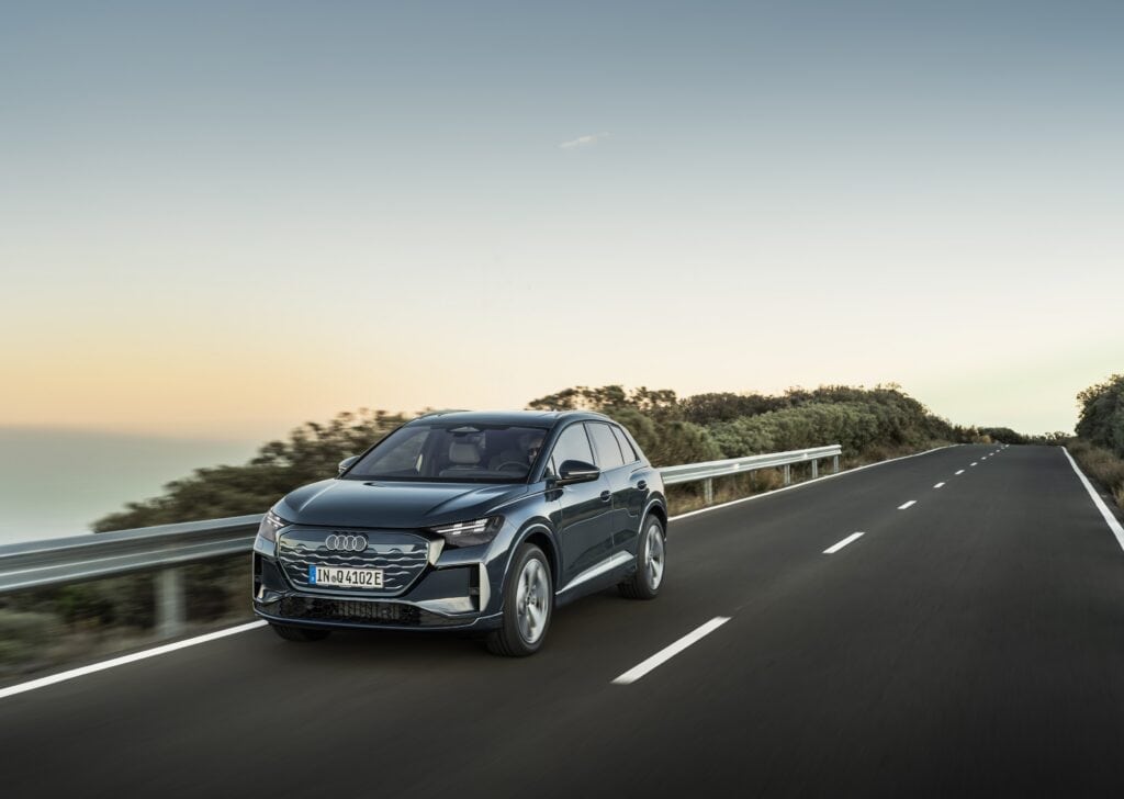 Audi Q4 SUV e-tron Plasma blue, outdoor dynamic photo, exterior, three-quarter front view