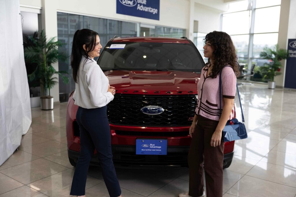 Customer discussing cardio with dealership salesperson courtesy of Ford