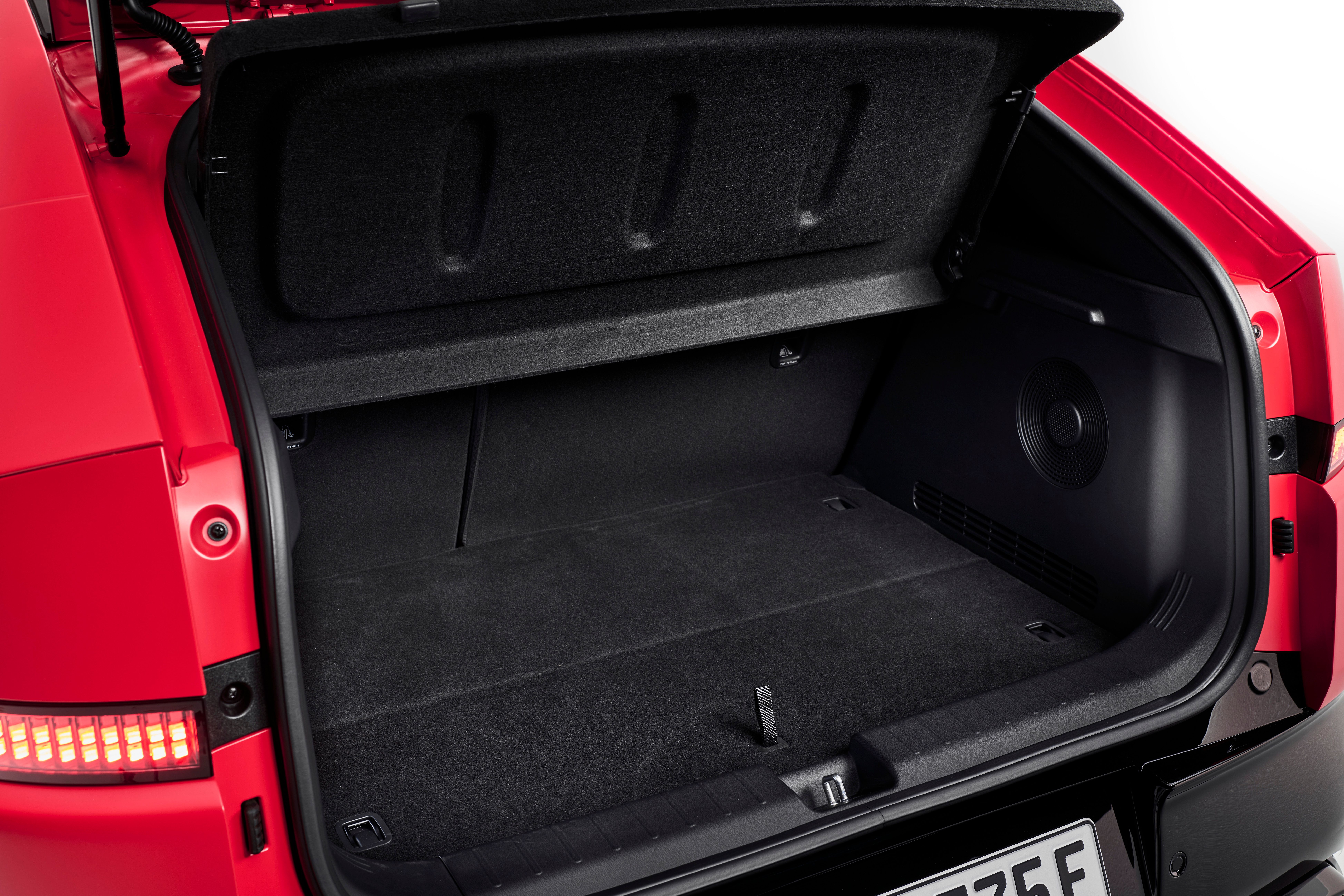 Open luggage compartment of a red Hyundai IONIQ 3 with its parcel shelf raised