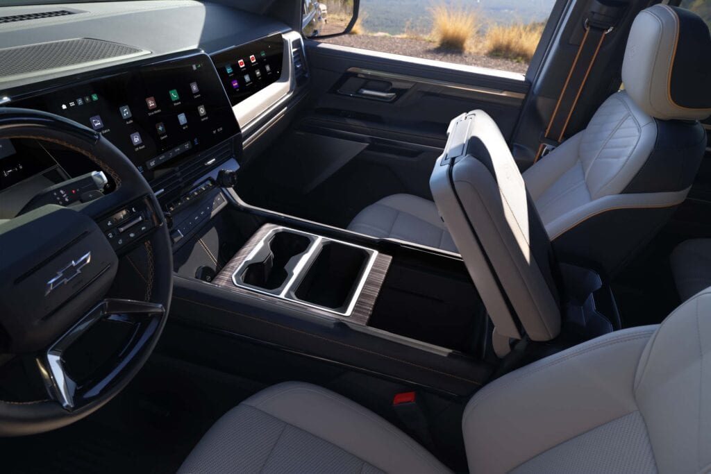 Multi-Flex center console with cup holders in forward position with console up. 2027 Chevrolet Silverado 1500 High Country with Enoki interior.