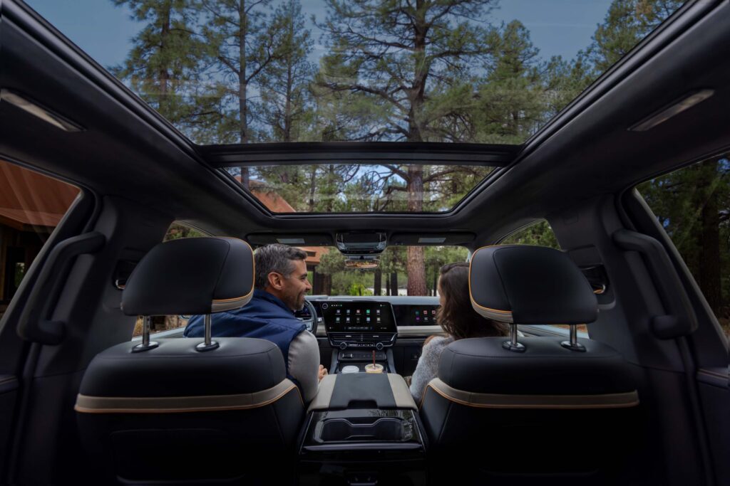 2027 Chevrolet Silverado 1500 High Country with Enoki interior. Interior view from the second row featuring Enoki interior and panoramic sunroof.