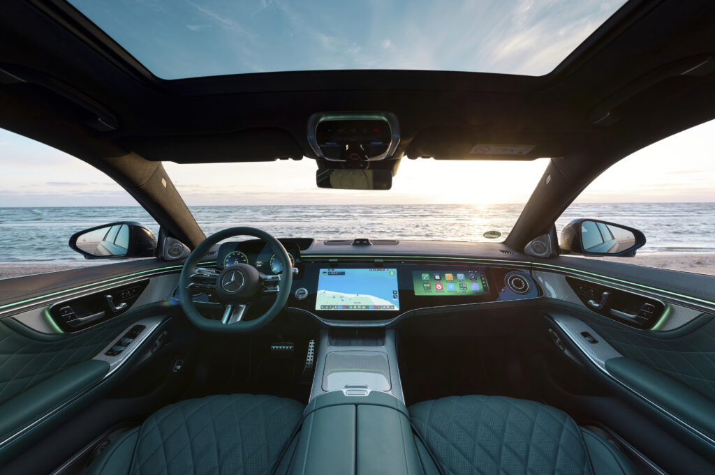 Mercedes-Benz S-Class dashboard with steering wheel and multiple digital displays.