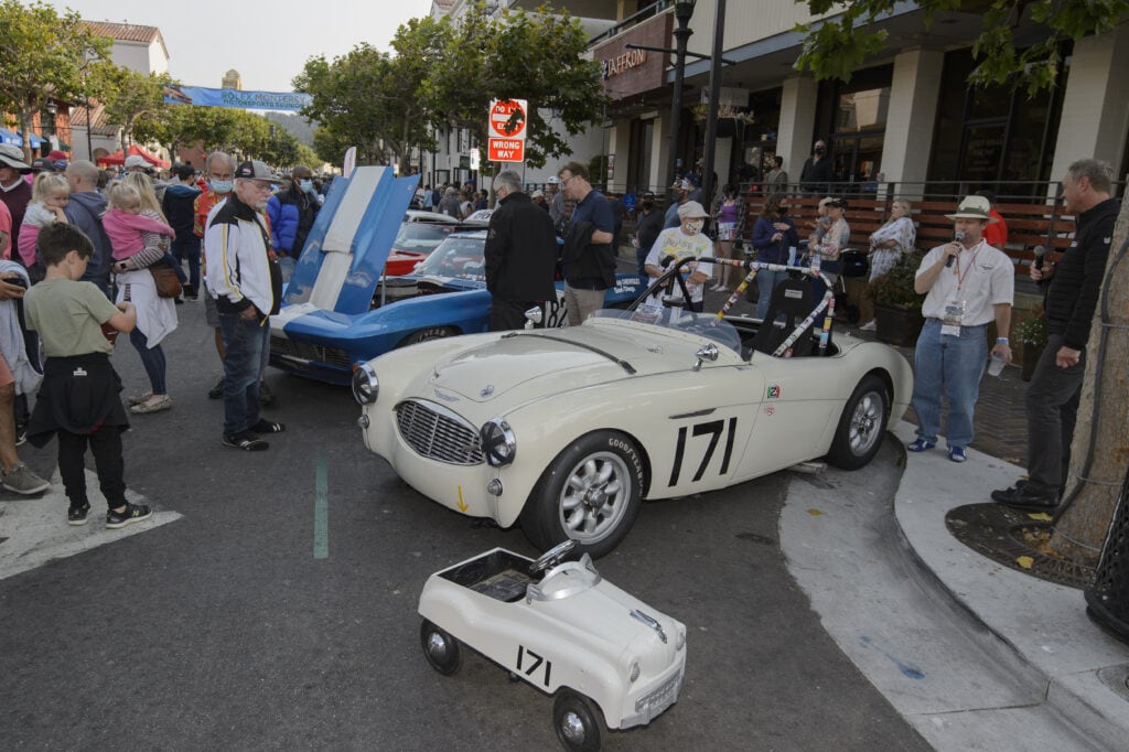 Crowd overlook some of the classic cars at the kickoff Monterey car week