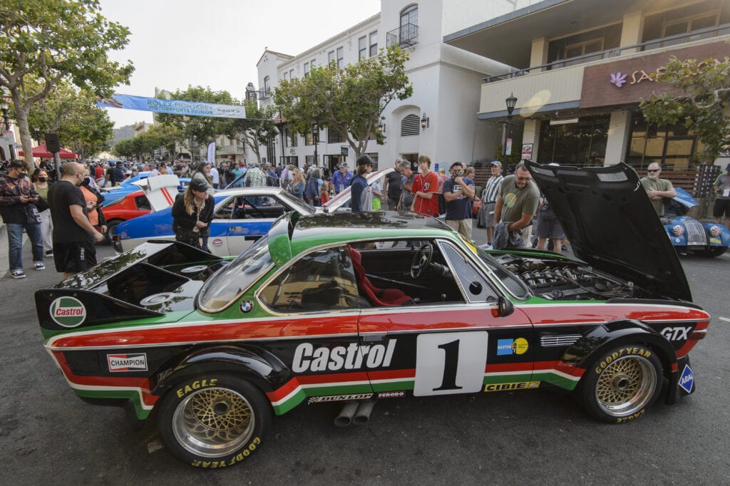 Crowd overlook some of the classic cars at the kickoff Monterey car week