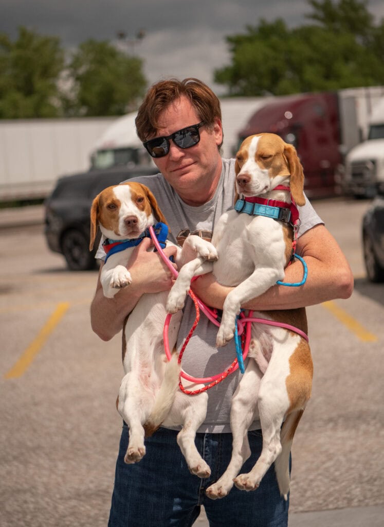 Roberto Baldwin holds two of the rescue dogs on this year's Operation Frodo EV