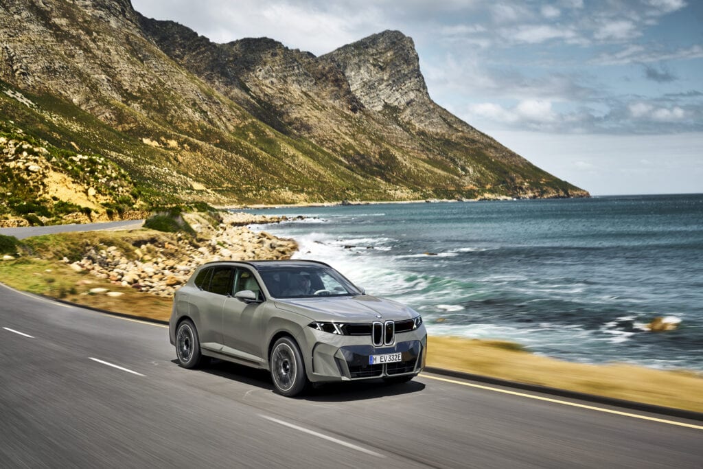 BMW X5 driving along a coastal road