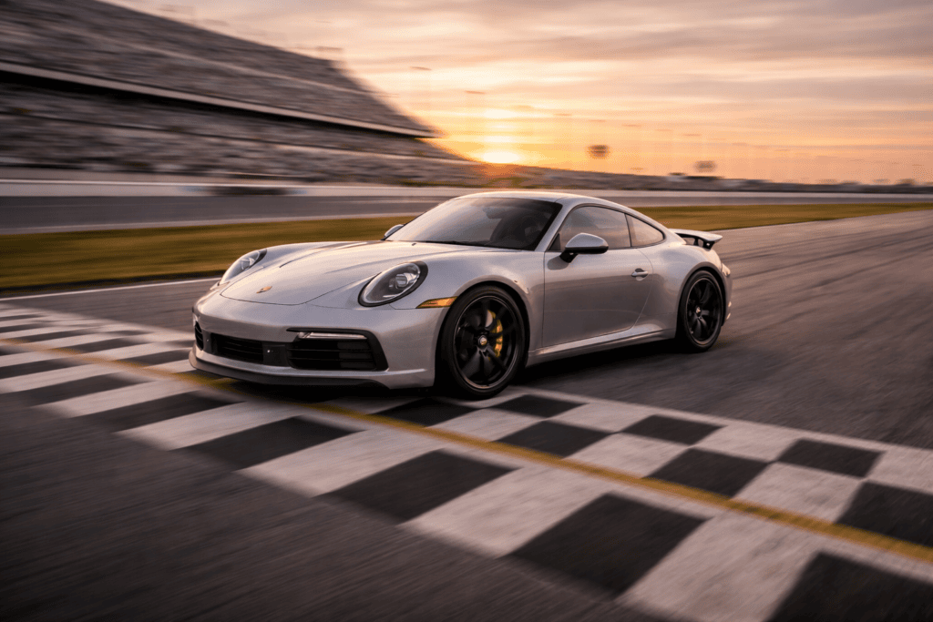 Porsche 911 crossing the finish line on a racetrack