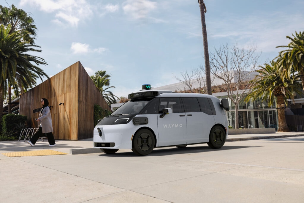 Waymo Ojai robotaxi parked next to a curb.