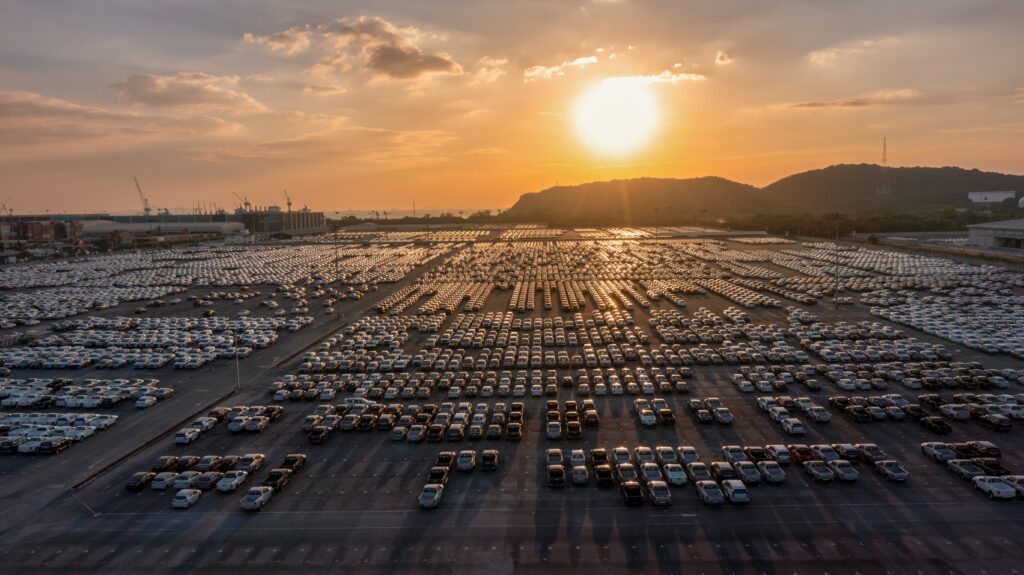 Envato Thousands of cars sit, waiting to go to dealerships to be sold
