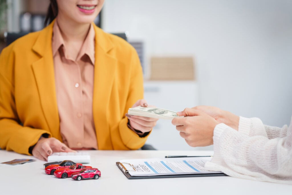 Handing over cash for a new car
