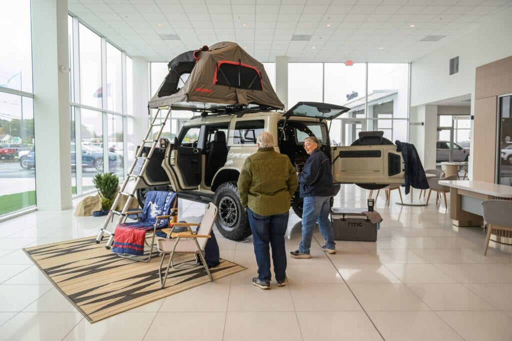 Buyers looking at vehicles in dealer showroom