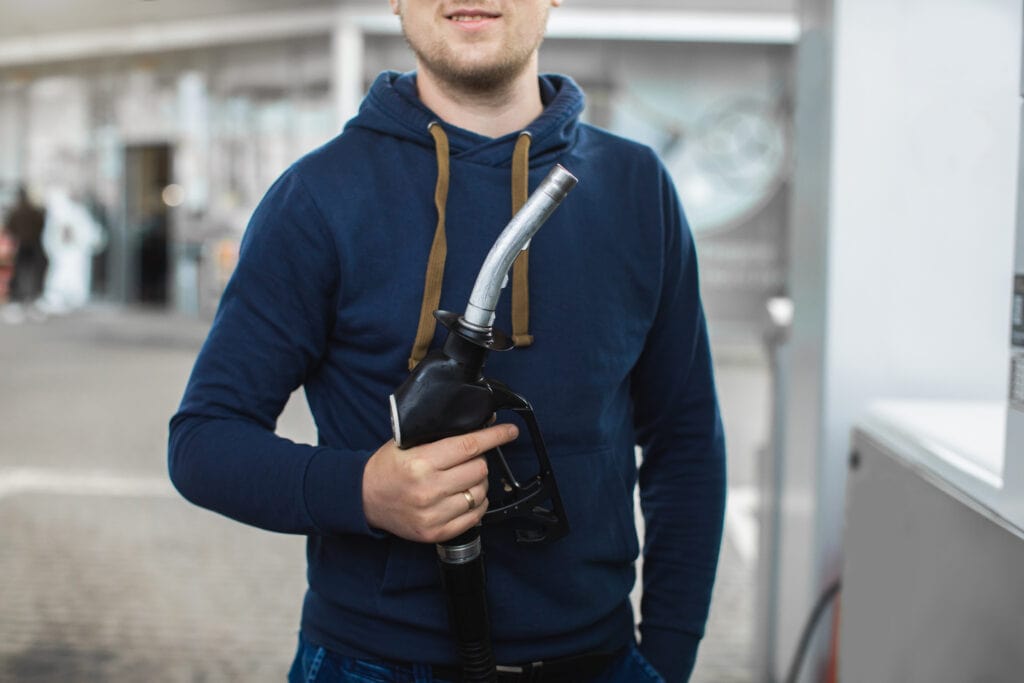 Guy holding gas nozzle