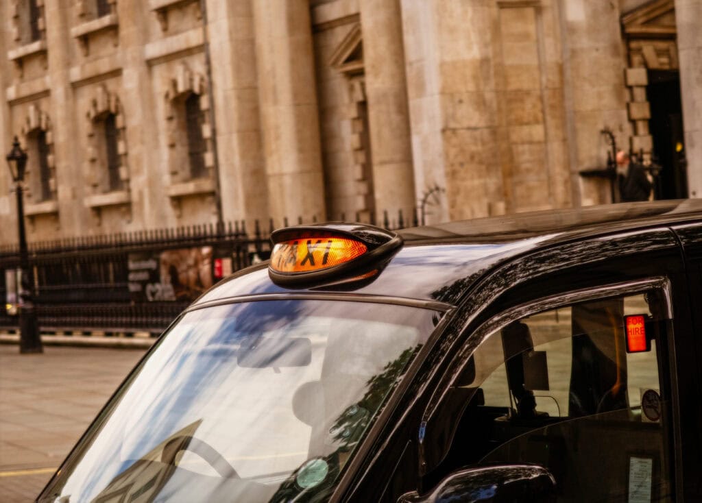 A view of London black cab taxi for hire around Trafalgar square