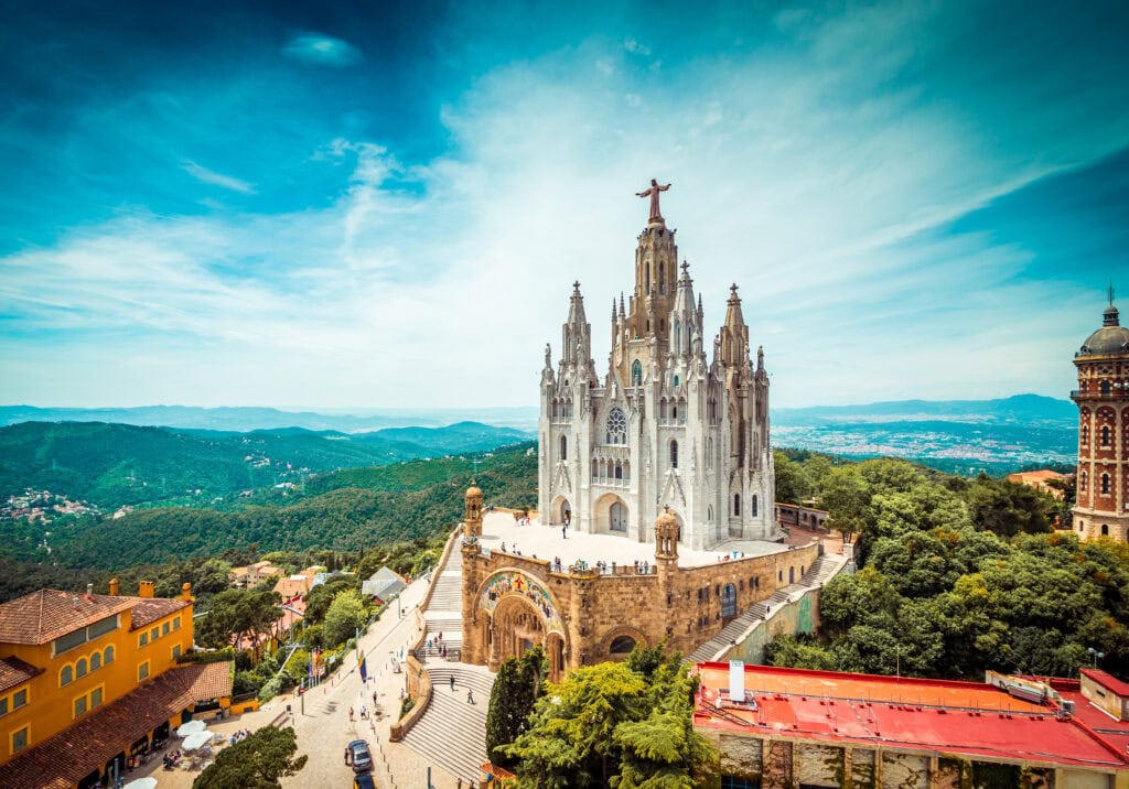 Tibidabo church on mountain in Barcelona with christ statue overviewing the city