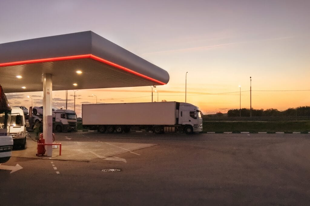 Diesel truck passing a diesel fueling station on the highway