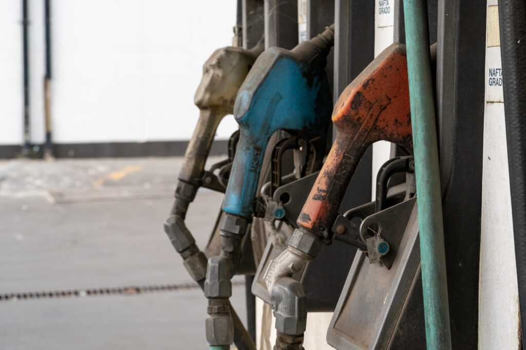 A row of an old dirty gas pump nozzle in a gasoline station